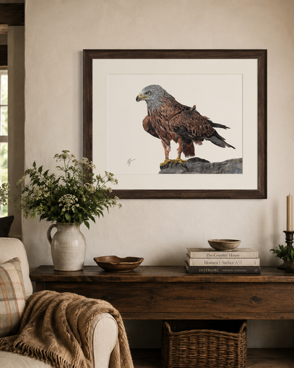 A framed art print of a brown hawk hanging on a beige wall above a rustic wooden console table in a styled living room setting.