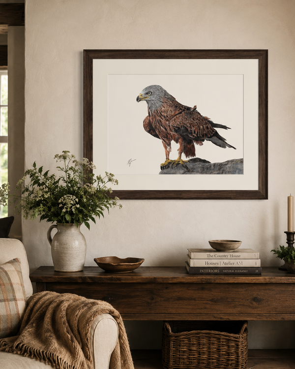 A framed art print of a brown hawk hanging on a beige wall above a rustic wooden console table in a styled living room setting.