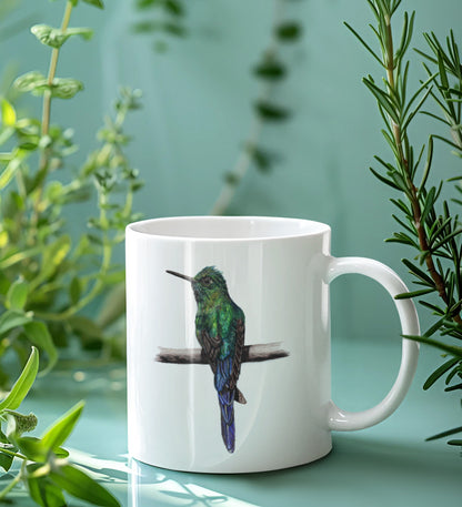 White mug with a bird design on a light green background with plants