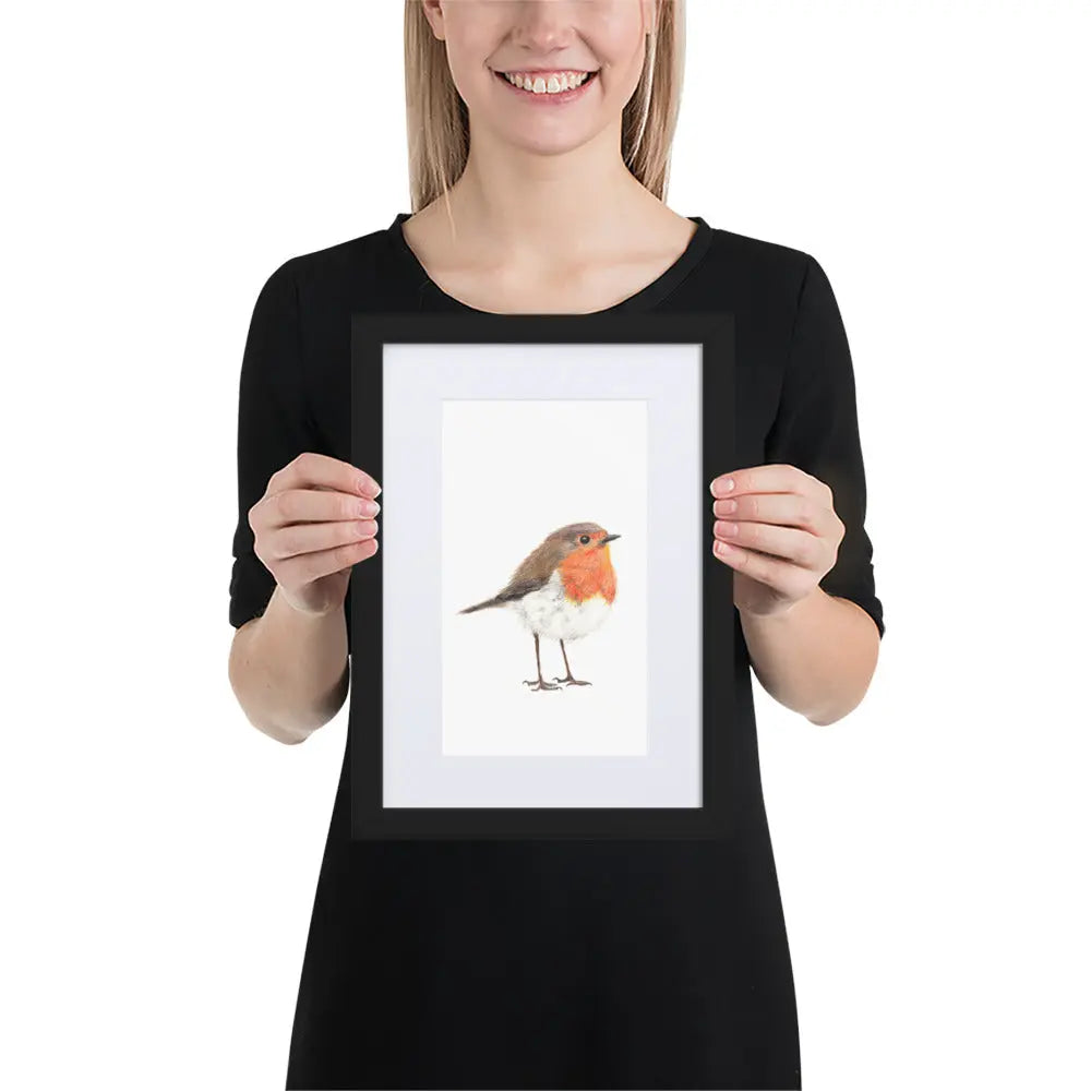 Person holding a framed picture of a bird
