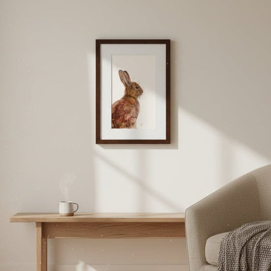 Living room with a framed picture of a rabbit on the wall, a beige sofa, and a wooden coffee table.