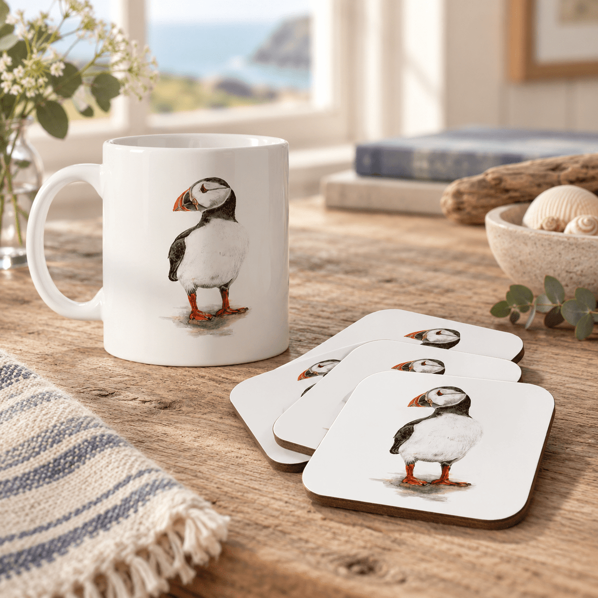 Puffin mug and four matching coasters styled in a warm coastal home