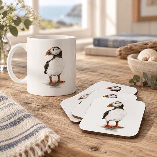 Puffin mug and four matching coasters styled in a warm coastal home
