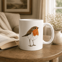 Robin mug with hand-drawn wildlife artwork styled in a cosy reading nook